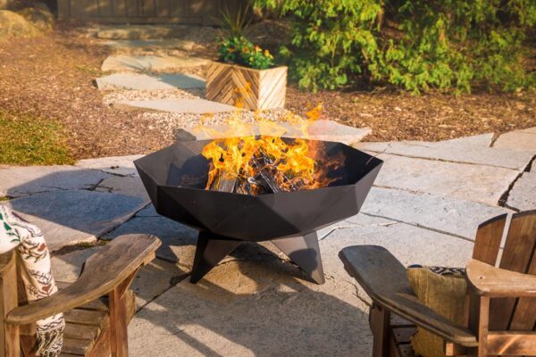 a large polygon shaped fire pit containing a large outdoor fire