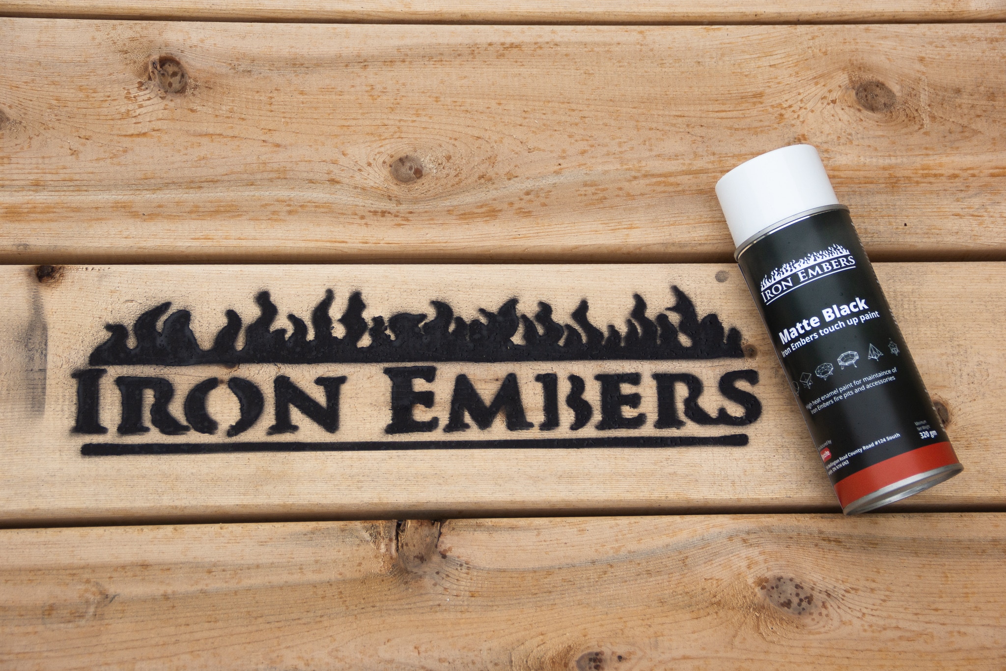 Painted iron embers logo on wood slats with a touch up can of high heat paint