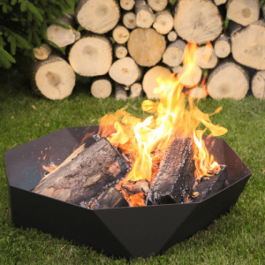 Cupola fire ring on a lawn with lots of fire wood nearby