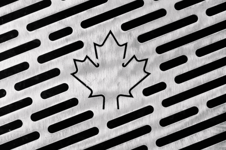 Maple leaf cutout on a fire pit stainless steel grill