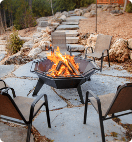 Large heavy-duty fire pit on natural stone patio.