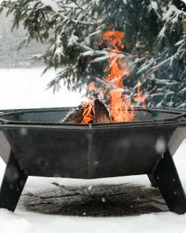 3' Cottager fire pit burning during the winter snow.
