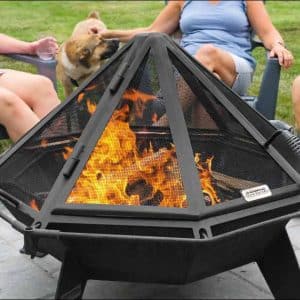 People enjoying a fire in large fire pit with a spark screen
