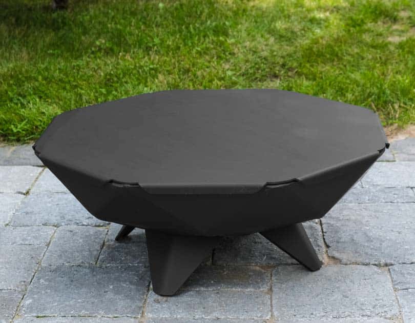 Table top and snuffer on a small modern steel fire pit