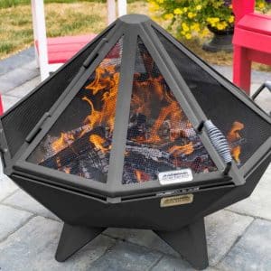 Burning fire pit with a spark screen that has a large access door for tending the coals
