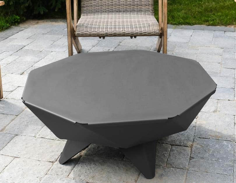 Fire pit with useful table top accessory on patio