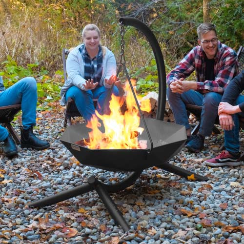Unique pendant hanging fire pit on gravel with people enjoying it.