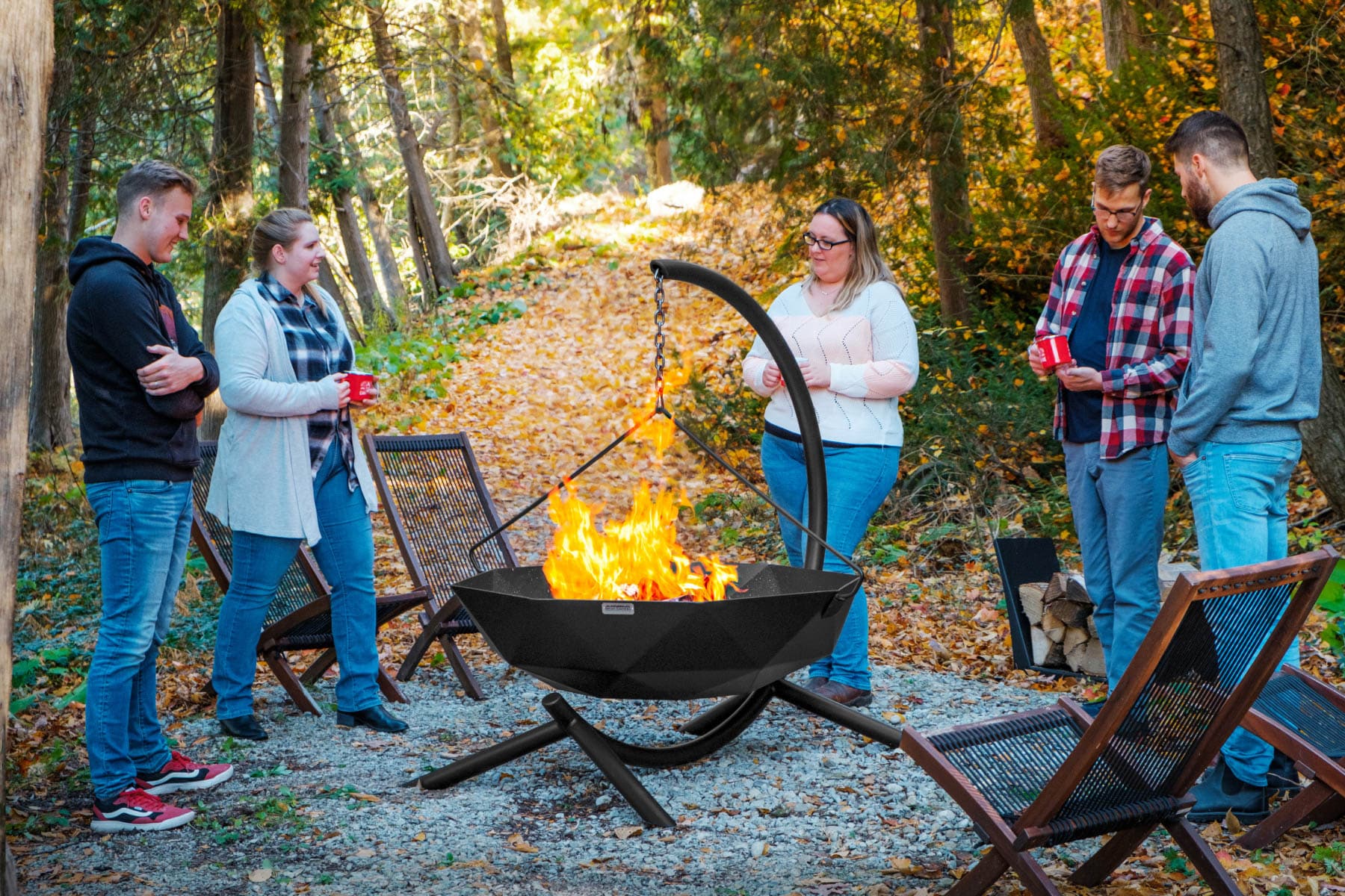 People using hanging fire pit in the fall