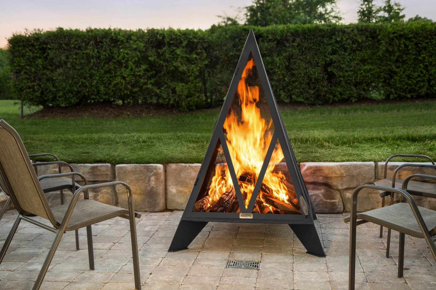 Pyramid fire pit on a patio in summer