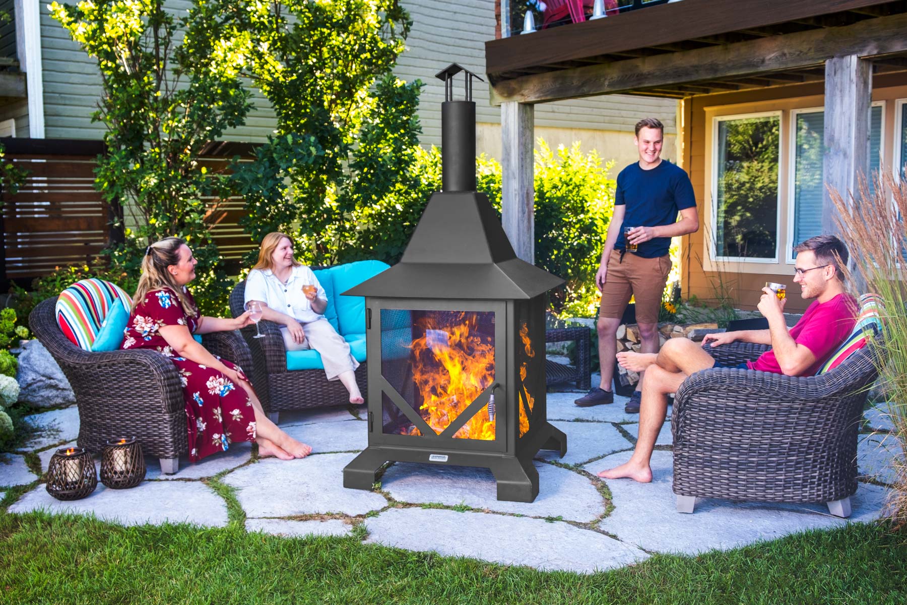 People sitting around chiminea fire pit