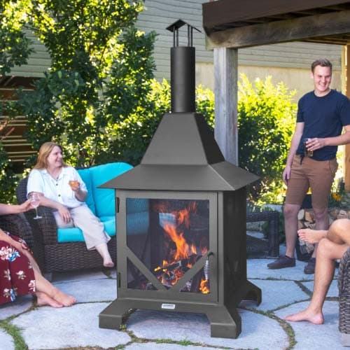 Tall chiminea fire pit on patio with friends enjoying