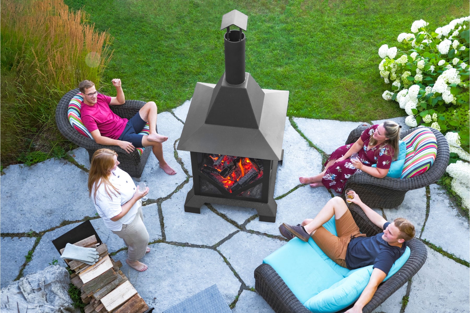 Friends gathered around large 7 foot tall chiminea fire pit