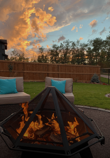 Cottager fire pit on a gravel pad surrounded by couches