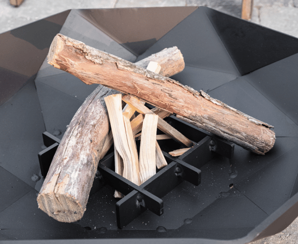 Building a fire in a Polygon fire bowl with a steel grate