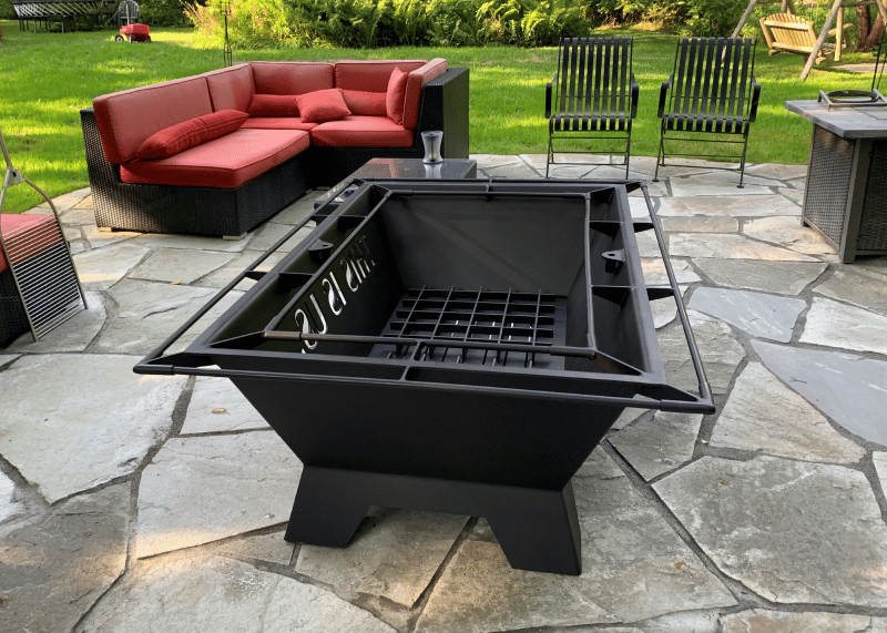 Large square fire pit on flagstone patio