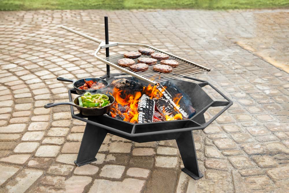 A small outdoor fire pit being used as a bbq